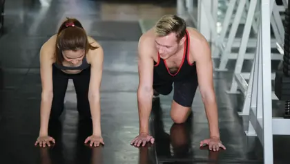 Two people working out at a gym Two people working out at a gym