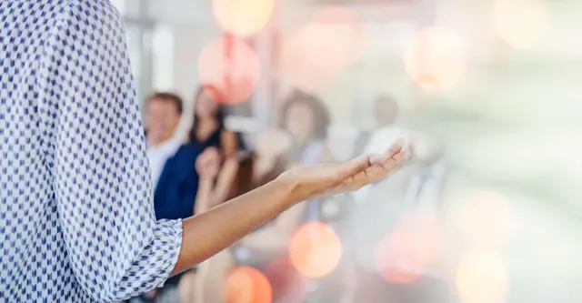 Speaker's hands gesturing towards audience Speaker's hands gesturing towards audience