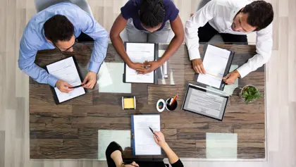 People working together in an office People working together at a table in an office