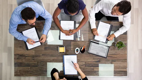 People working together in an office People working together at a table in an office