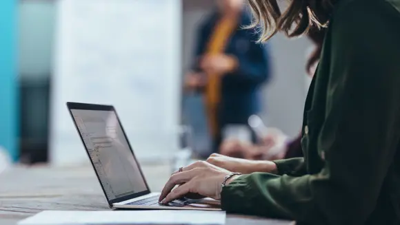 Person working at a laptop.  Person working at a laptop.