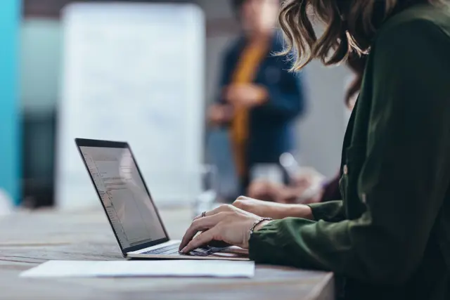 Person working at a laptop.  Person working at a laptop.