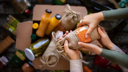 Two people holding a food donation 