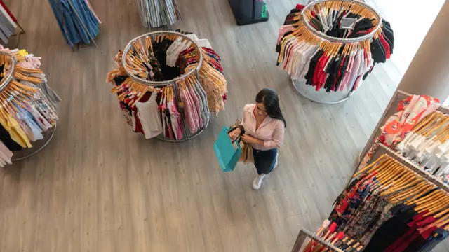 Woman in a retail clothing store Woman in a retail clothing store