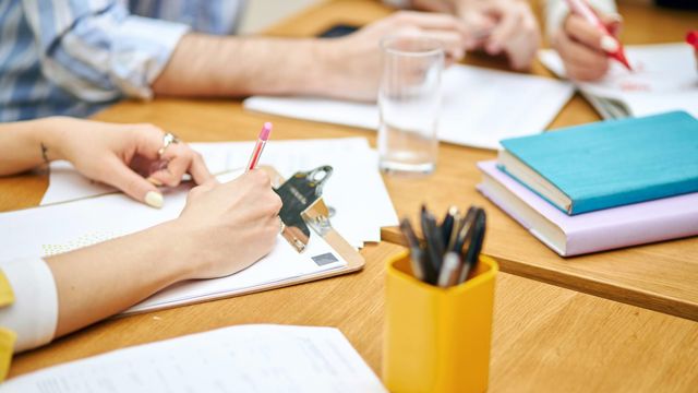 People taking notes at a table