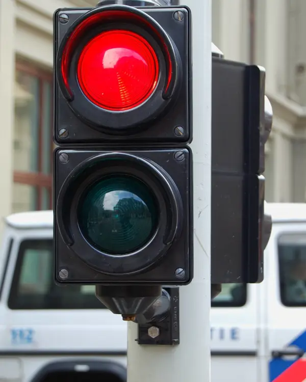 An image of a traffic light showing red colour on the street An image of a traffic light showing red colour on the street
