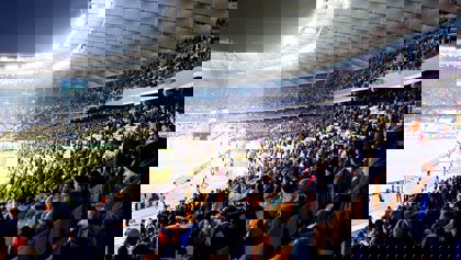 People sitting in a sports stadium People sitting in a sports stadium