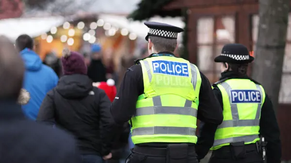 Image of 2 British police officers in high visibility yellow jacket Image of 2 British police officers in high visibility yellow jacket