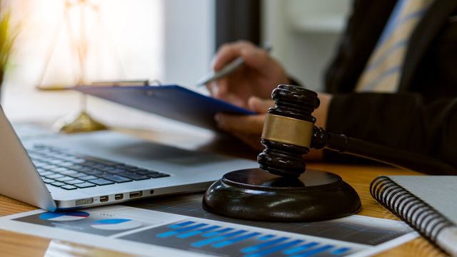 Judge gavel beside a laptop