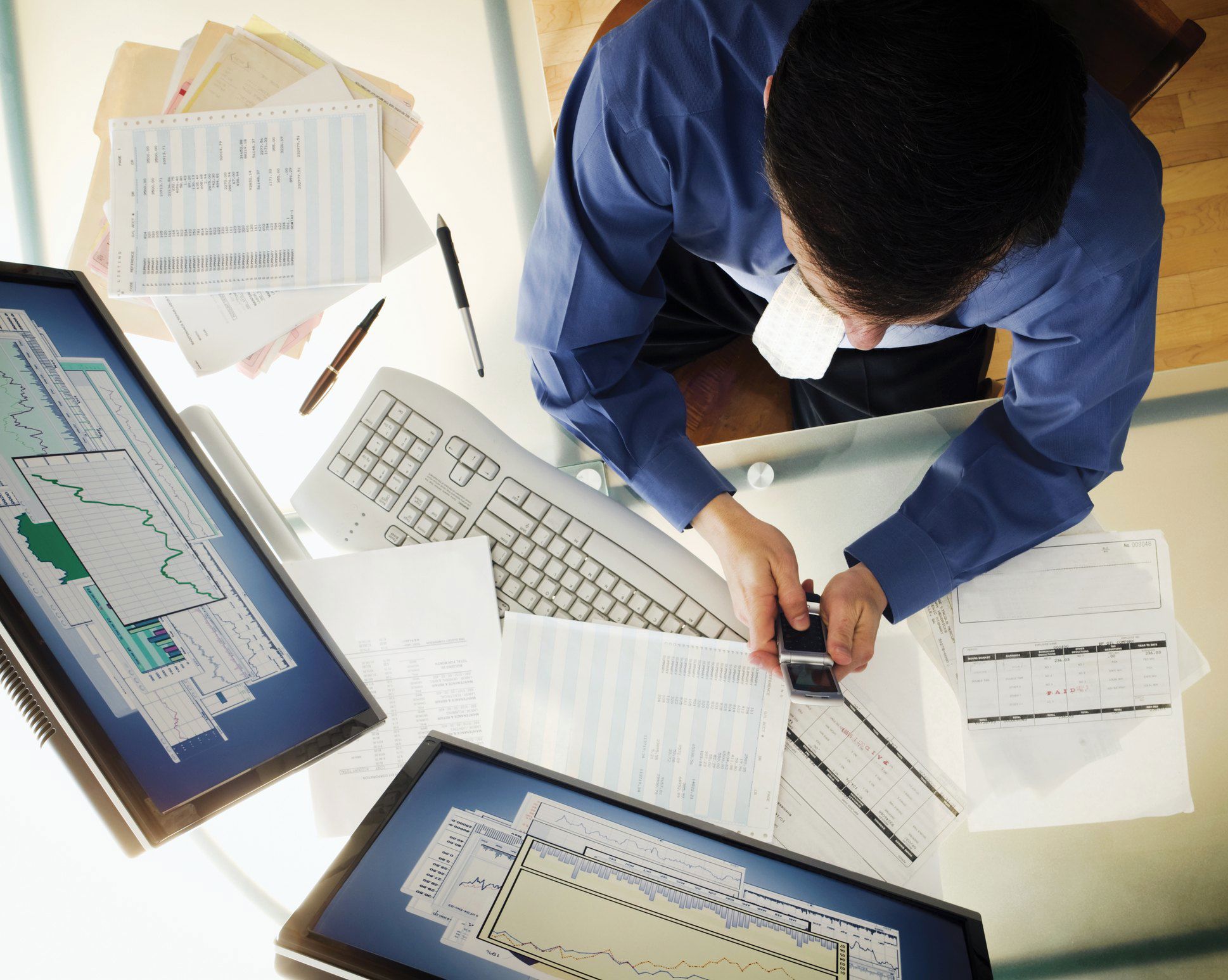 Person working at a desk and using technology Person working at a desk and using technology