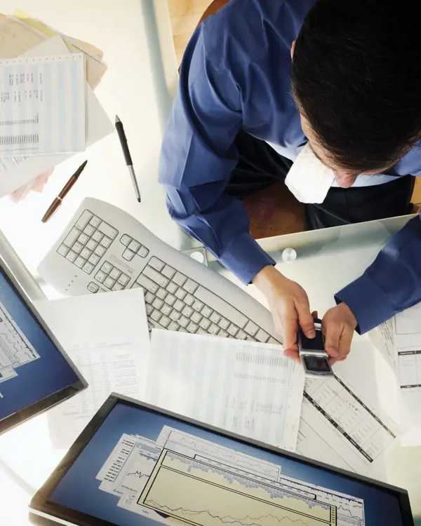 Person working at a desk and using technology Person working at a desk and using technology