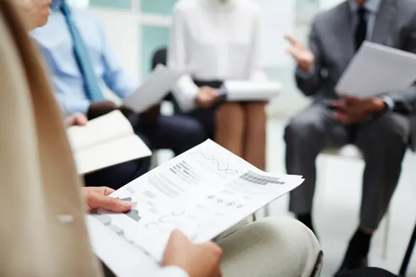 Person holding a document with graphs Person holding a document with graphs