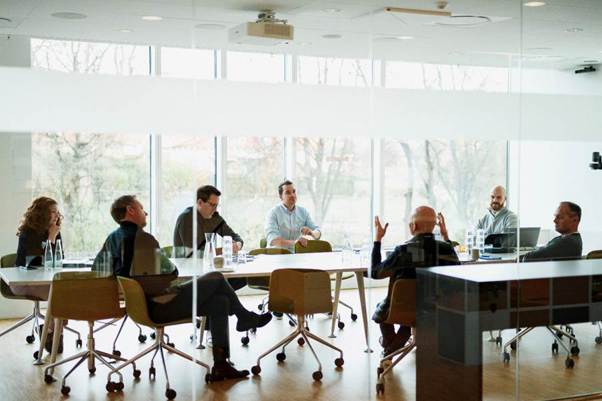 A group of people sitting around a table
AI-generated content may be incorrect.